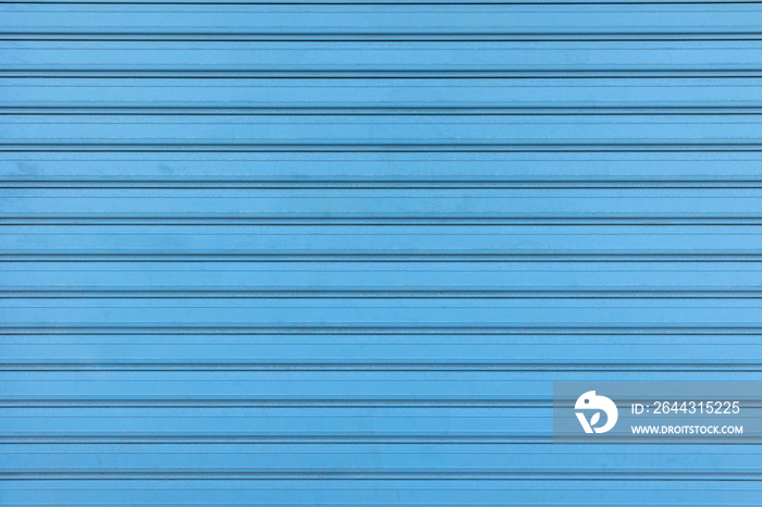 backdrop with horizontal lines of a weathered blue garage door