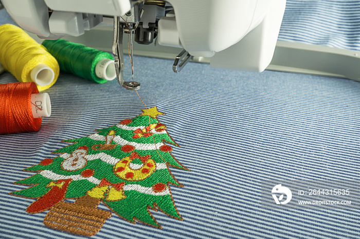 Background of close up image embroidery machine and embroidered  lovey christmas tree  have text space