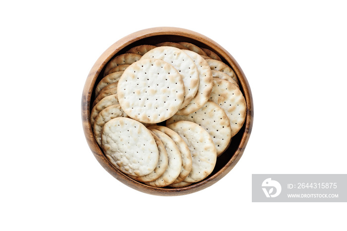 Isolated wooden bowl of water crackers over a white background. Clipping path included. Image shot from overhead.