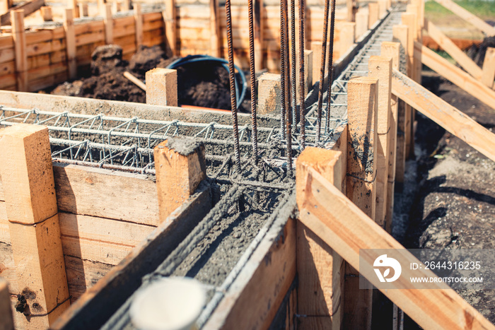 Foundation site of new house, building, details and reinforcements with steel bars and wire rod, preparing for cement pouring