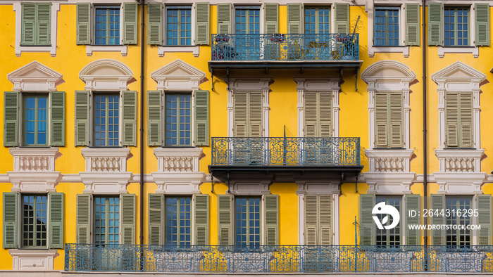 Nice in France, colorful facade, with typical murals windows and green shutters, place Garibaldi, detail