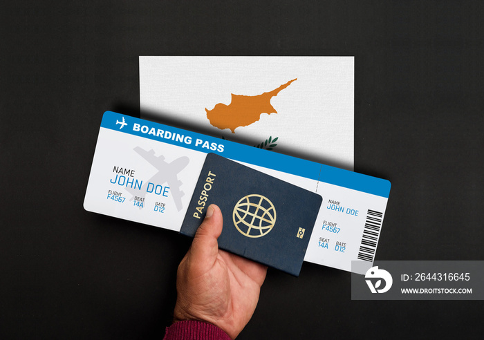 Hand holds passport and boarding pass with flag of Cyprus