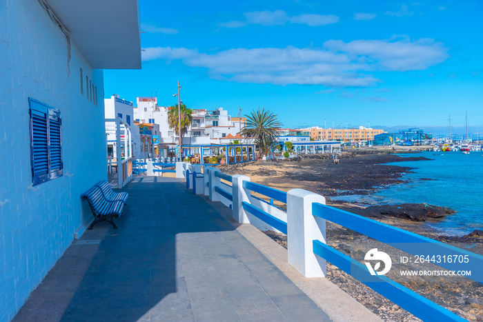 People are enjoying a sunny day at a beach in Corralejo, Fuerteventura, Canary islands, Spain