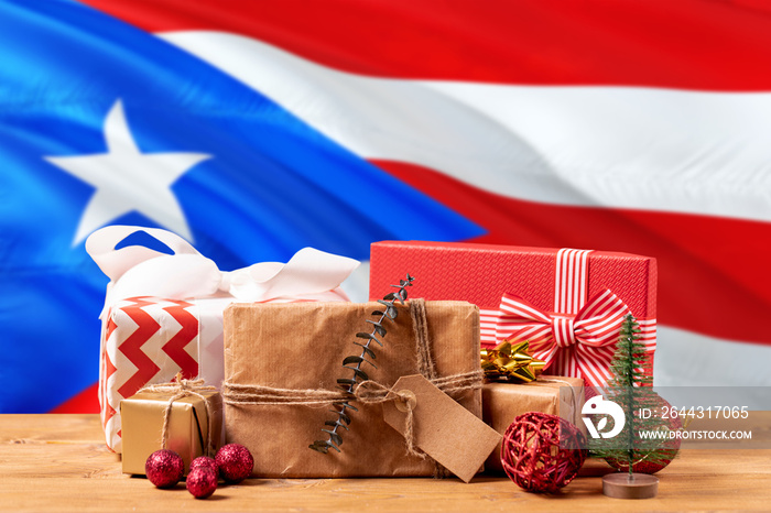 Puerto Rico new year celebration theme. Wrapped christmas gifts on waving national flag background. Merry christmas concept.