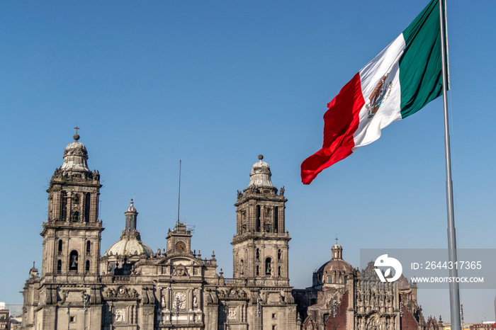 mexico city cathedral with mexican big flag waving