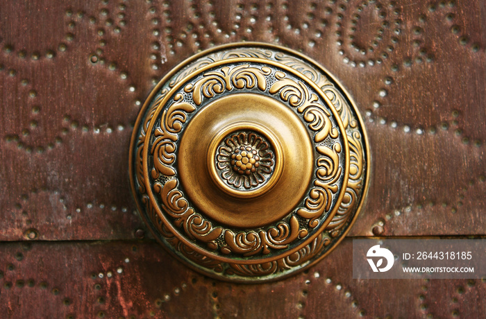 Golden knob on wooden door