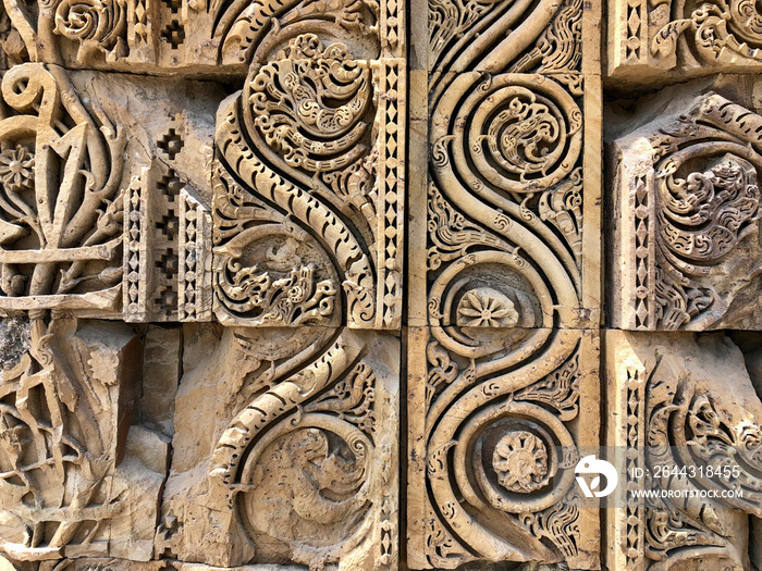 Floral Motfis decoration in the wall of Qutb Minar complex at New Delhi, India. Relief carving at the old monument. Unesco heritage site at Delhi.