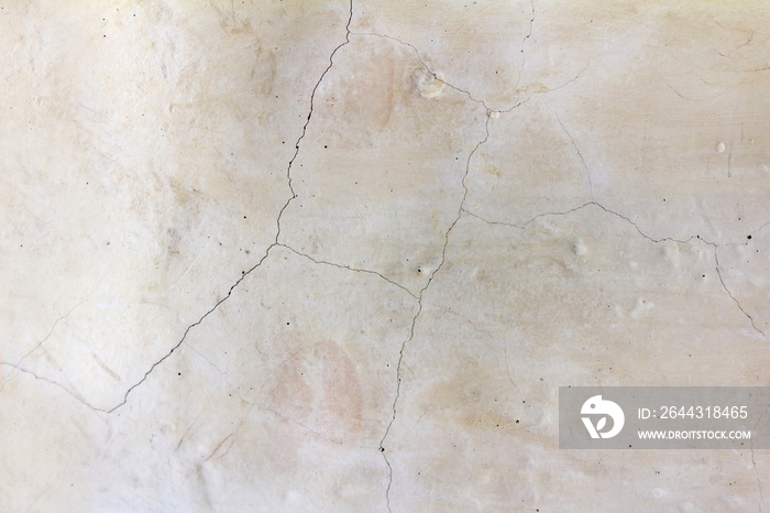 Close-up photo texture of worn and cracked marble wall.