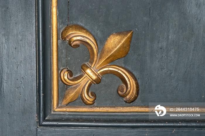 Fleur de Lis symbol on old wooden background. Rome. Italy.