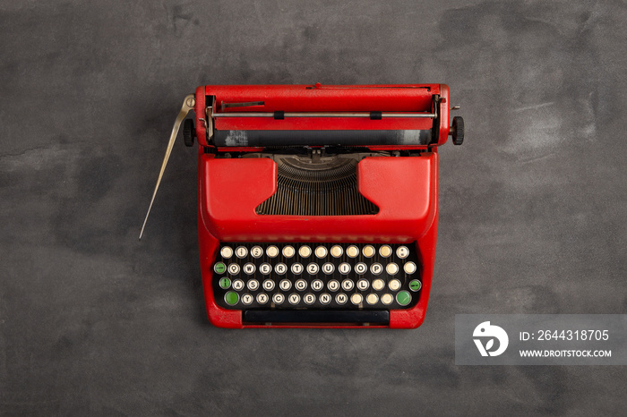 Journalism or blogging concept - vintage typewriter on the grey desk, top view