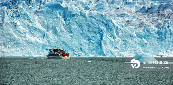Cruise boat in front of Perito Moreno Glacier in Patagonia, Argentina, South America; guided boat tour on lake.