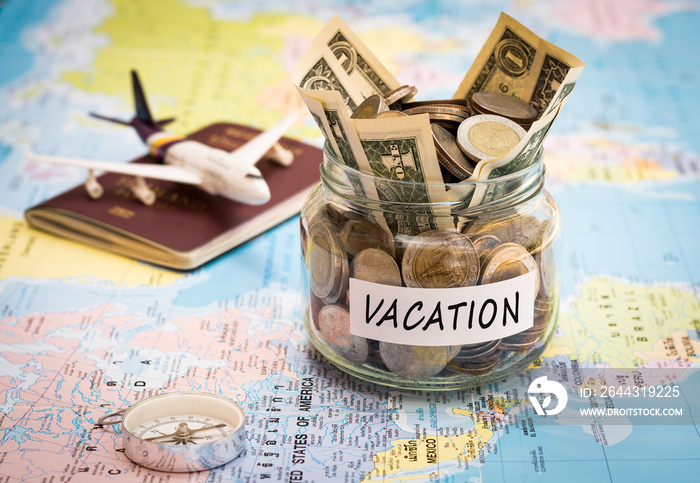 Vacation budget concept with compass, passport and aircraft toy