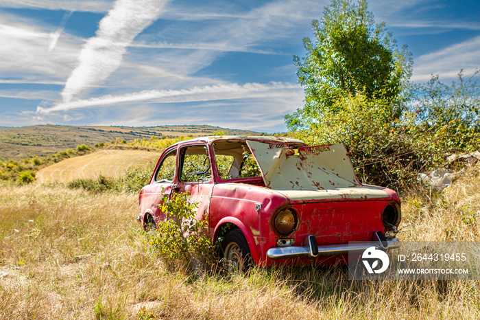 old abandoned red car in the countryside