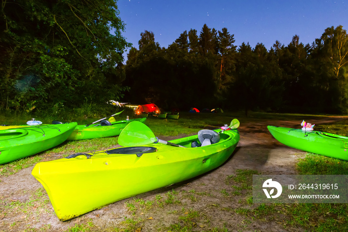 Drying canoe or kayak in a nighttime in tourist camp. Camping. Tourist halt.