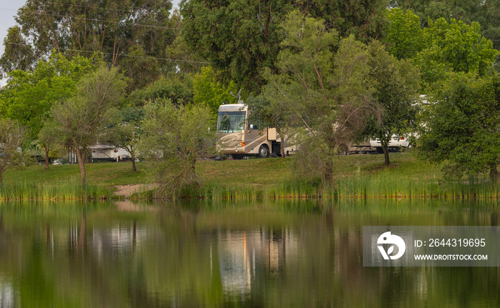 Rv Camping along the shore at Lake Camanche in the spring with reflection in water