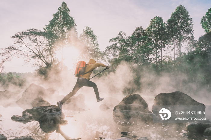 Happy tourists having fun with travel amid morning fog over hot spring at Chae Sorn National Park, Thailand