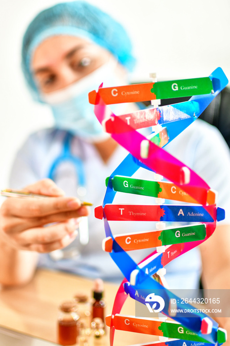 Medical Tutor Holding Model Of Double Helix During Presentation