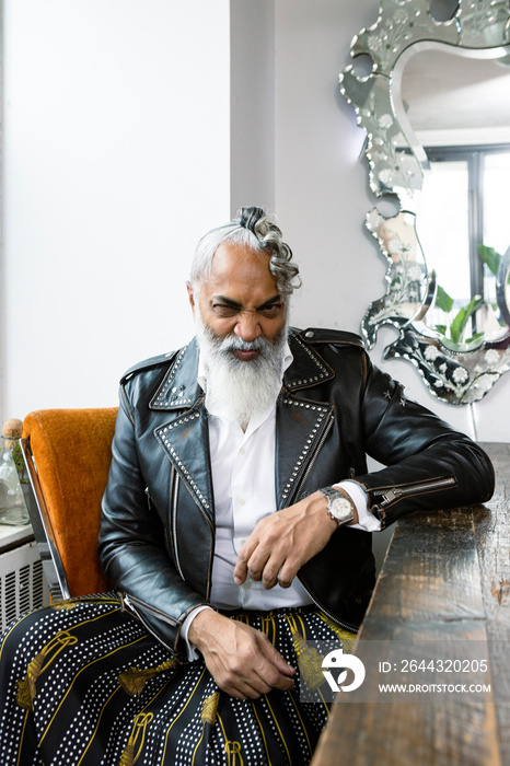 portrait of man making a funny expression with grey beard