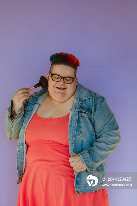 portrait of a plus size woman with makeup brush