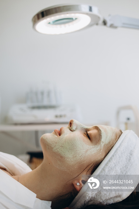 Close up of cosmetologist do beauty face procedures or treatment to woman client in aesthetic medicine clinic. Beautician doctor clean skin, make facial massage to patient. Cosmetology concept.