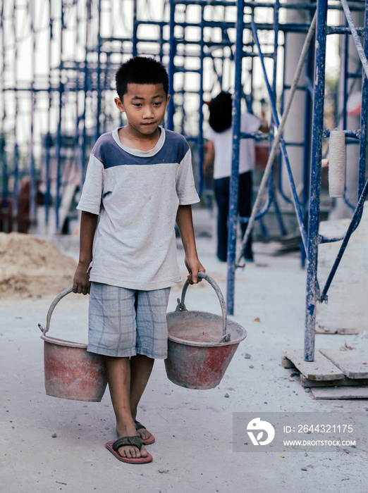 Children are forced to work in the construction area. Human rights concepts, stopping child abuse, violence, fear of child labor and human trafficking