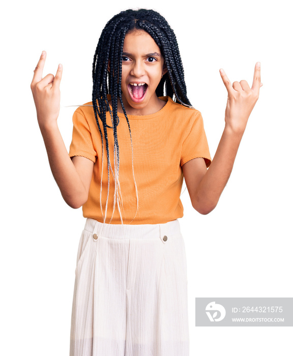 Cute african american girl wearing casual clothes shouting with crazy expression doing rock symbol with hands up. music star. heavy concept.