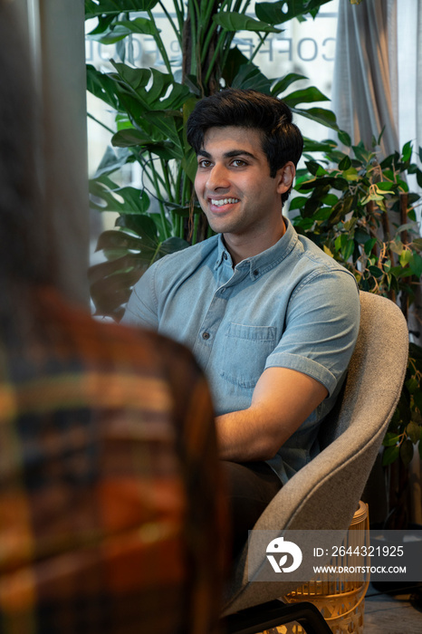 Colleagues talking at business meeting in office