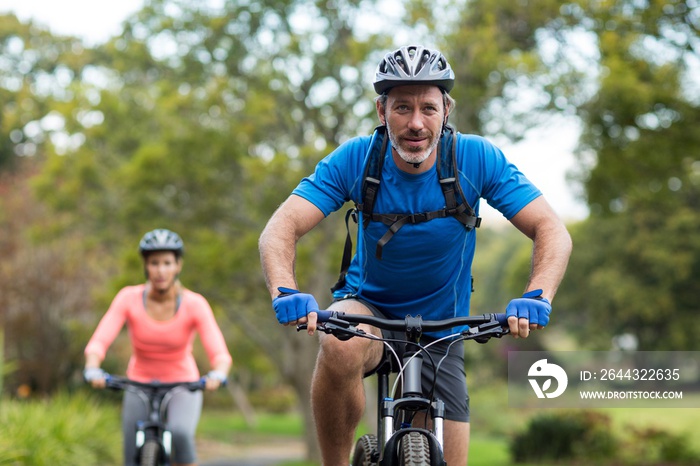 Athletic couple cycling on the road