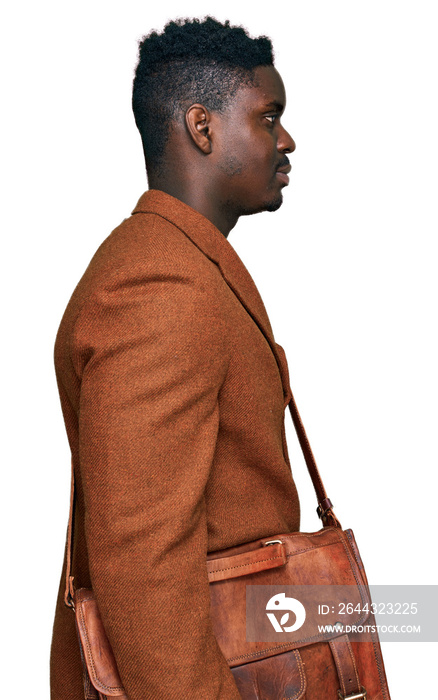 Handsome business black man wearing leather bag looking to side, relax profile pose with natural face with confident smile.