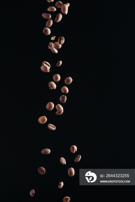 Coffee beans in flight on a dark background