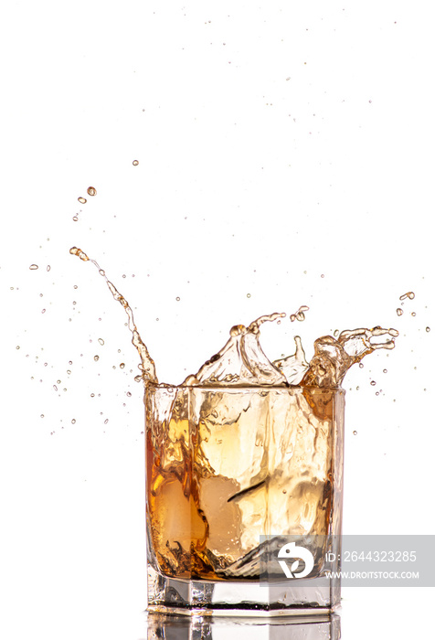 big splash from falling ice in a glass of whiskey on a white background