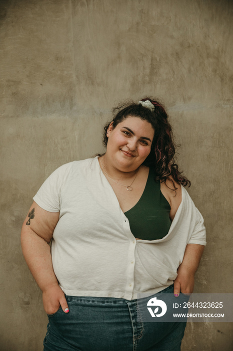 portrait of a plus size woman smiling and looking at camera