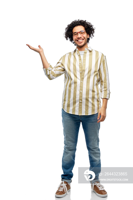 people and fashion concept - happy smiling man in glasses holding something on his hand over white background