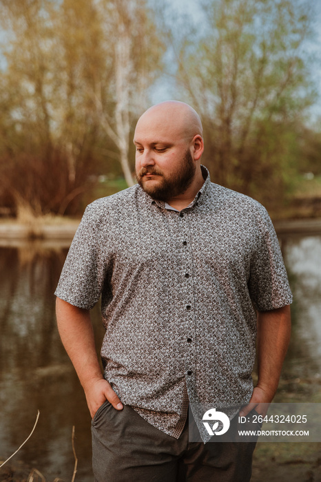 closeup of plus size bald man looking down