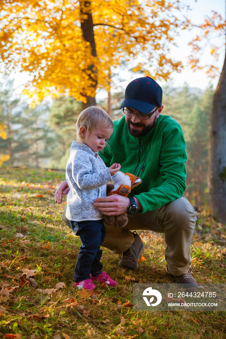 father and daughter in the autumn park