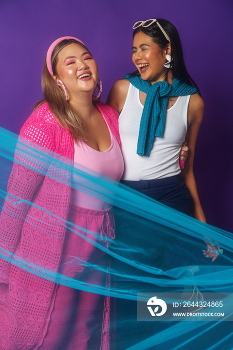 Asian duo fashion colour-blocked studio portrait