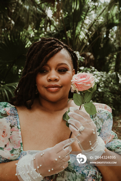 plus size black woman holds rose