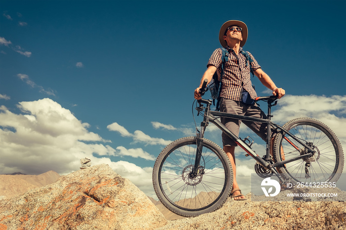 Bikeer traveler with bicycle portrait in Himalayas mountain