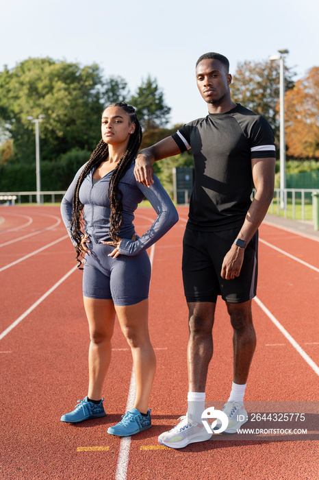 Couple of athletes standing at sports track