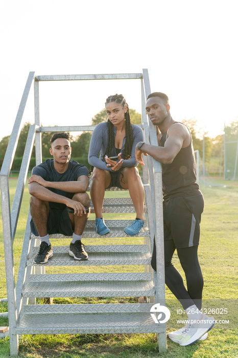 Group of athletes sitting on steps at stadium