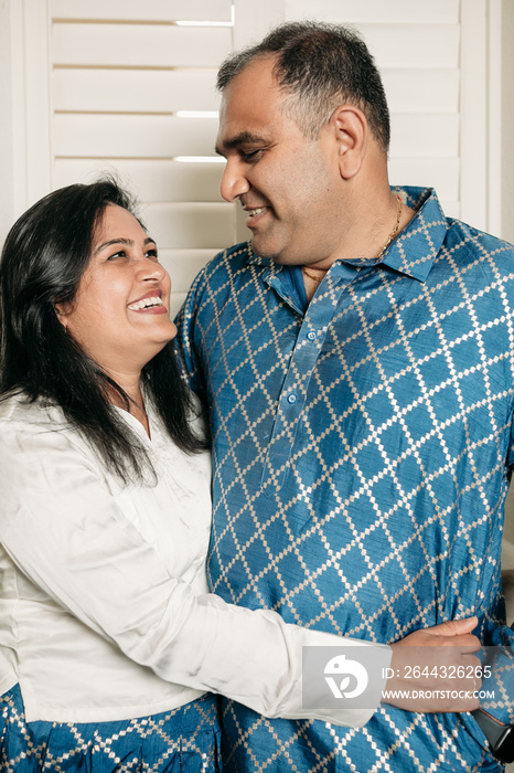 South Asian couple cooking in the Kitchen