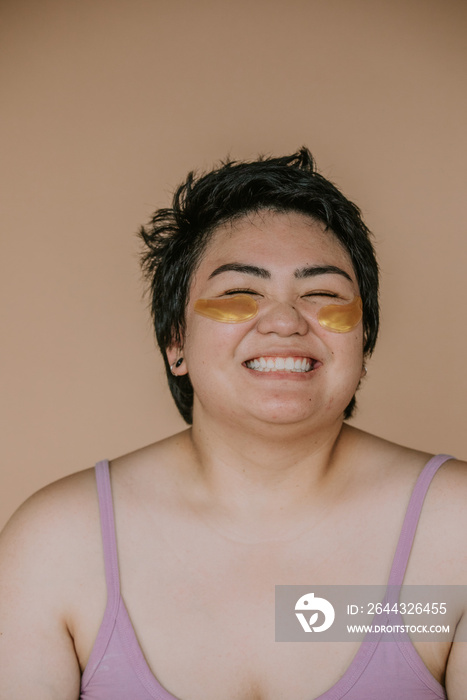 plus size filipino woman with eye care smiling