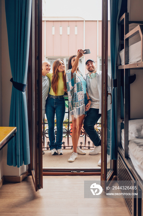 college students take a selfie on the balcony of the room - vertical photo