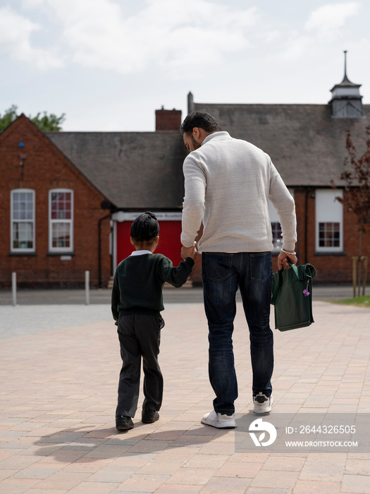 Father walking son (6-7) to school