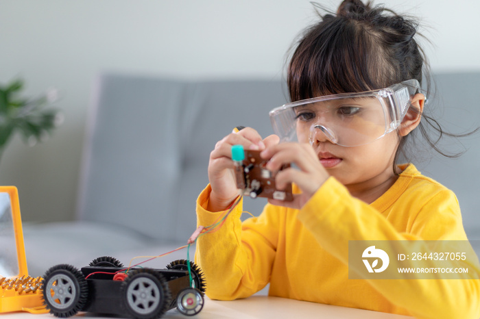 Asia students learn at home in coding robot cars and electronic board cables in STEM, STEAM, mathematics engineering science technology computer code in robotics for kids concept.