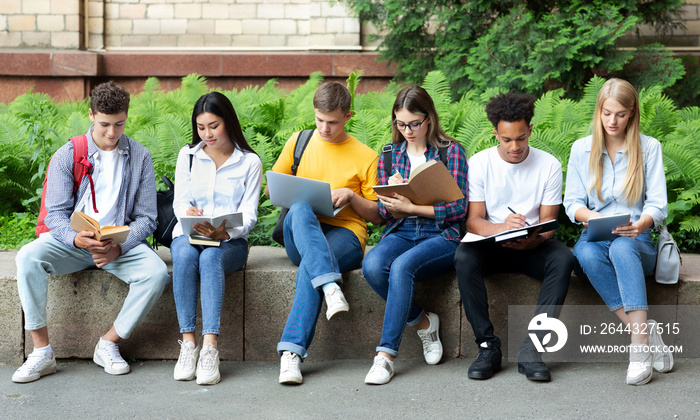 College classmates preparing for lecture in university campus