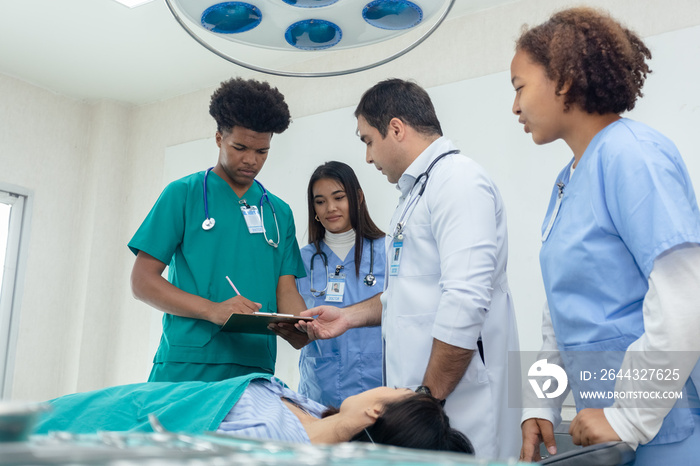 professional medical teacher give tuition group students in patient operating room.