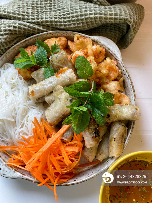 Homemade bobun. Vietnamese noodles with spring rolls and shrimp