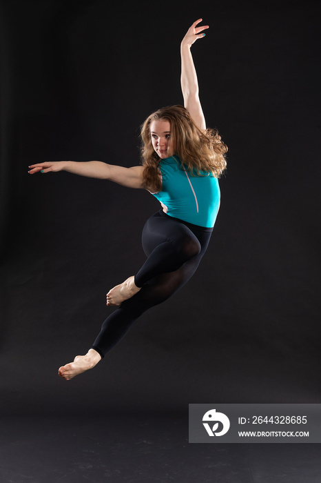 Portrait of young ballet dancer jumping in the air