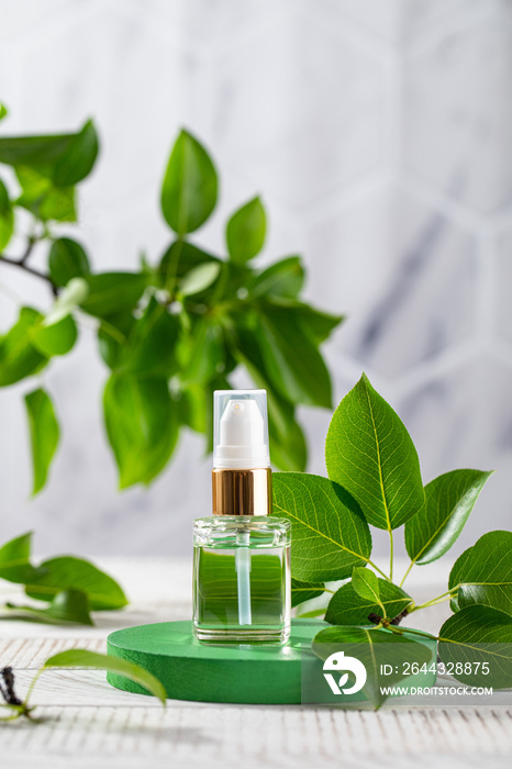 Serum for the skin of the face in a dropper on a green podium among the leaves. The concept of natural cosmetics.